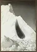 Grotto in an iceberg, with geologist T. Griffith Taylor and physicist Charles Wright, reverse view of Ponting's famous image, 5 January 1911