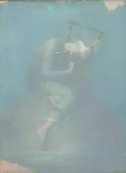 blurry photograph of a blindfolded girl sitting on an orange