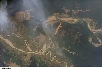 Satellite view. The long strip is Homalin Airport. The meandering Uyu river can be seen joining the Chindwin river south of the town.