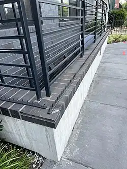 Pins prevent pedestrians from resting on ledge