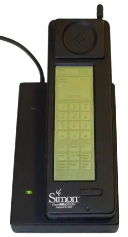 Photograph of the Simon Personal Communicator shown in its charging base