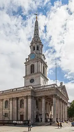 A white church with columns and an elaborate steeple