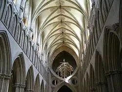 an interior view of the nave at Wells as described in the text. The nave terminates abruptly in a structure known as St Andrew's Cross, which was inserted to support the tower.
