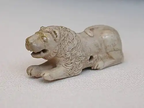 Old Kingdom gaming piece of ivory. Set of 6, 3 lions, and 3 bulldogs; Abu Rouash, Tomb M, 1st Dynasty, 3.5 × 6.5&nbsp;cm, Cairo Museum[4]