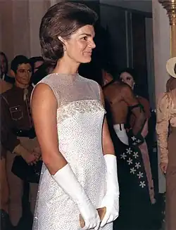 Jacqueline Kennedy wearing evening gloves at a state dinner in 1962.