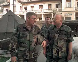 Colonel Jeffrey Hage of the United States National Intelligence Center (USNIC) in Bosnia escorts Abrams through the center during Operation Joint Endeavor in 1996