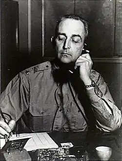 Black and white photo of Lieutenant Colonel Lester J. Whitlock sitting at a desk.