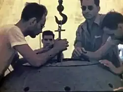 Louis Slotin (with sunglasses) and Harry Daghlian Jr. (seated middle) during the Trinity Test preparation in July 1945. Both died following supercriticality accidents.