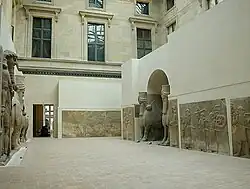 Louvre – human-headed winged bulls and reliefs from Dur-Sharrukin, in their wider setting of reliefs