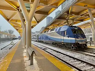 Platform and wooden canopy, with a train stationed, at Lucien-L'Allier station