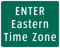 A road sign indicating the entrance to a county with Eastern Time observed