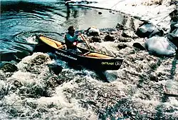 A canoeist on the Ramapo River, New York State, USA.