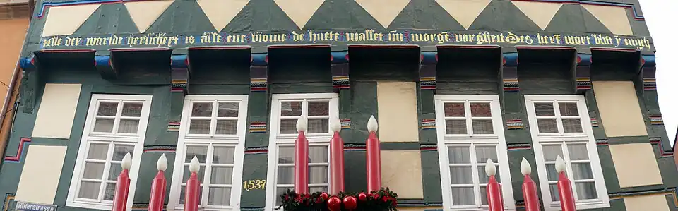 Inscription in Middle Low German on a house at Hameln that translated into English reads All the world's magnificence is like a flower that grows today and vanishes tomorrow; the Lord's word remains in eternity.