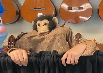A 2-puppeteer-operated hand puppet of a Chimpanzee