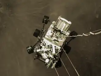 The rover photographed from the sky crane during descent