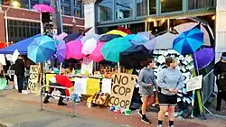 Outdoor market, protected by colorful umbrellas