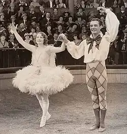 Man an woman taking bows before a crowd