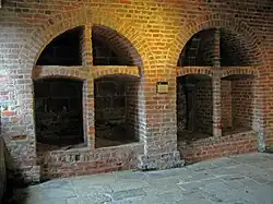 Two brick-built arched wine bins, each divided into four sections, the lower ones being larger than the upper