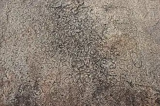 Old Kannada inscription dated 1309 CE, of Kampilideva, the Raja of the Kampili Kingdom, on a rock face of the Hemakuta hill in Hampi.