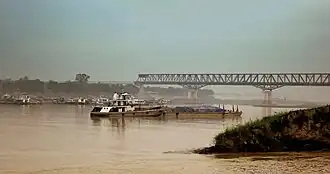Ferries plying on the river with the bridge in the backdrop