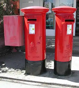 Father and daughter pair: George VI and Elizabeth II pillar boxes at Bembridge Post Office Isle of Wight. One was for local mail and the other for off-island post.