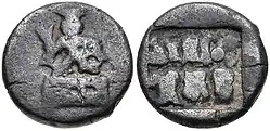 Coin of the Panchalas of Ahichhatra (75-50 BCE). Obv Indra seated facing on pedestal, holding bifurcated object. Rev Idramitrasa in Brahmi, Panchala symbols.