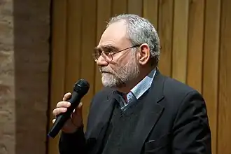 Magee in 2014, talking into a microphone