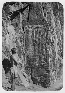 Man looking at rock art in 1941