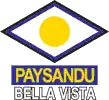 A squashed diamond shape with a blue outline, in the centre is a yellow circle, underneath are the words "PAYSANDU BELLA VISTA"