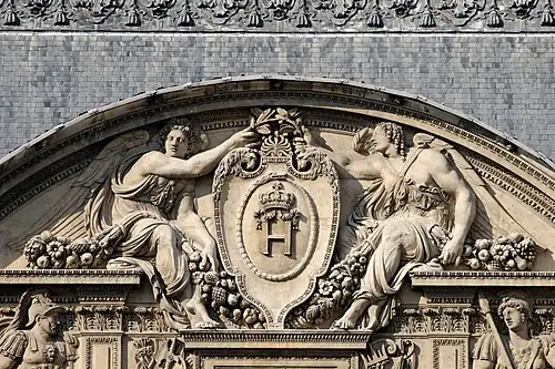 Renaissance cartouche in a pediment of the west facade of the Cour Carrée of the Louvre Palace, Paris, designed by Pierre Lescot, 16th century[7]