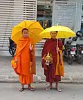 Two monks performing piṇḍapāta on Street 172, Phnom Penh, Cambodia