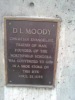 Bronze commemorative plaque mounted on a building wall