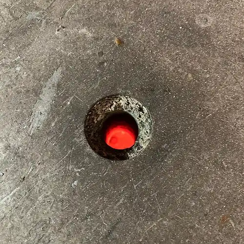 14. As soon as the enamel is melted, the firing is done. Since this is a relatively quick process (around a minute or less at this temperature), the firing is monitored through a peephole to make sure the enamel is not overheated.