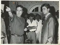 Praveen Nischol directing Shahrukh Khan on the set of English Babu Desi Mem