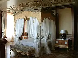One of the bedrooms in the residence with a canopy bed.