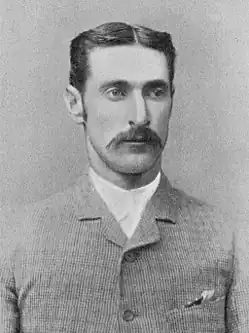 A black and white photo of a man showing his head and shoulders