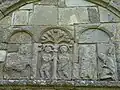 Arcade carvings: Adam and Eve and, at right, a warrior kneeling before a bishop