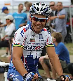 Image 4 Robbie McEwen Photo: John O'Neill Robbie McEwen, Australian professional road cyclist, wearing his Team Katusha (Russian: Катюша) cycling kit at the start of the 2010 Jayco Bay Cycling Classic. McEwen's accolades include winning the maillot vert (green jersey) overall Points Classification in the Tour de France three times, along with winning 12 individual stages, and competing in three Olympic Games. The green and gold bands around his arms identify him as an Australian National Cycling Champion. More selected pictures