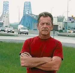 Rus Thompson standing in front of the South Grand Island Bridges