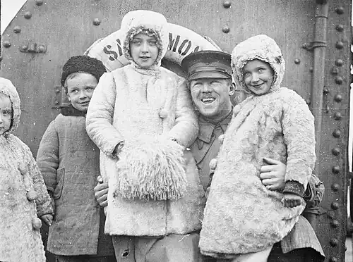 Refugee children that were separated from their parents during the Novorossiysk exodus with Lt. L.M. Foster, aboard the relief ship, Sangamon, March 1920