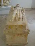 Sarcophagus of the priest kept in the Carthage Museum, white marble, formerly painted, 4th century BC, 72 × 193 × 65 cm.[J 1]