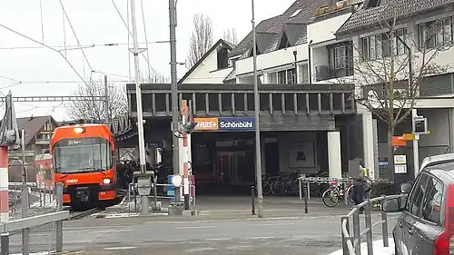 Red train next to canopy-covered platform
