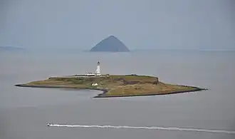 Pladda seen from the Isle of Arran, with Ailsa Craig in the background