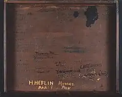 Inside of wooden desk with several names carved into it