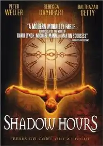 A man is suspended facing up by ropes tied to his wrists and torso. Up from him is a giant clock display.