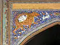 Mosaic representations the lion and sun on the façade of the Sher-Dor Madrasa (1636) at the Registan in Samarkand