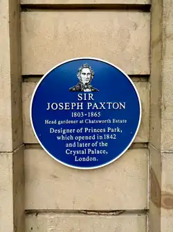 Plaque reads: "Sir Joseph Paxton. 1803-1865. Head gardener at Chatsworth Estate. Designer of Princes Park, which opened in 1842 and later of the Crystal Palace, London."