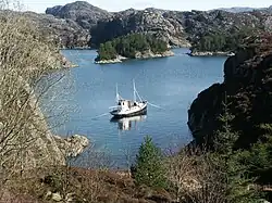 Fishing vessel anchored in a bay.