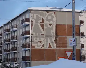 Original sgraffito and restored lattice-slatted balcony railings on building 1-464 in Tallinn