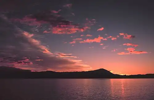 Sunrise in southeast Alaska. Sunsets and sunrises are sometimes pink because of an optical effect called Rayleigh scattering.